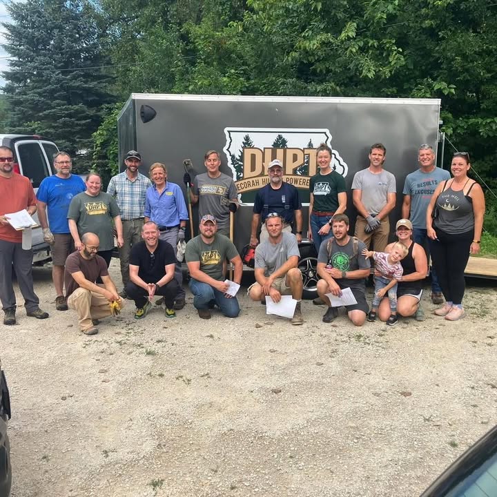 DHPT volunteers gathered by the organization's trail-work trailer